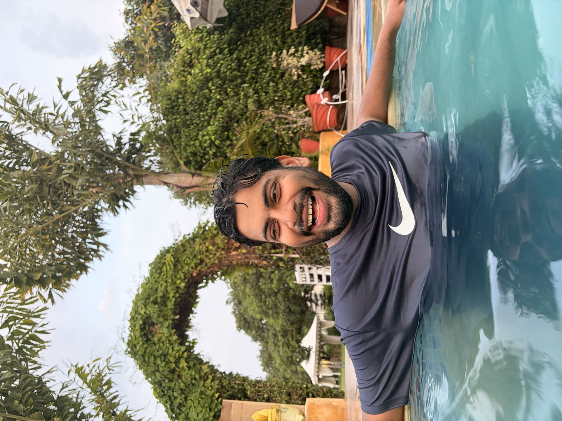 Ankit laughing in a pool