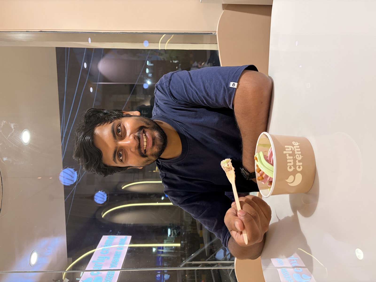 Ankit smiling while enjoying dessert