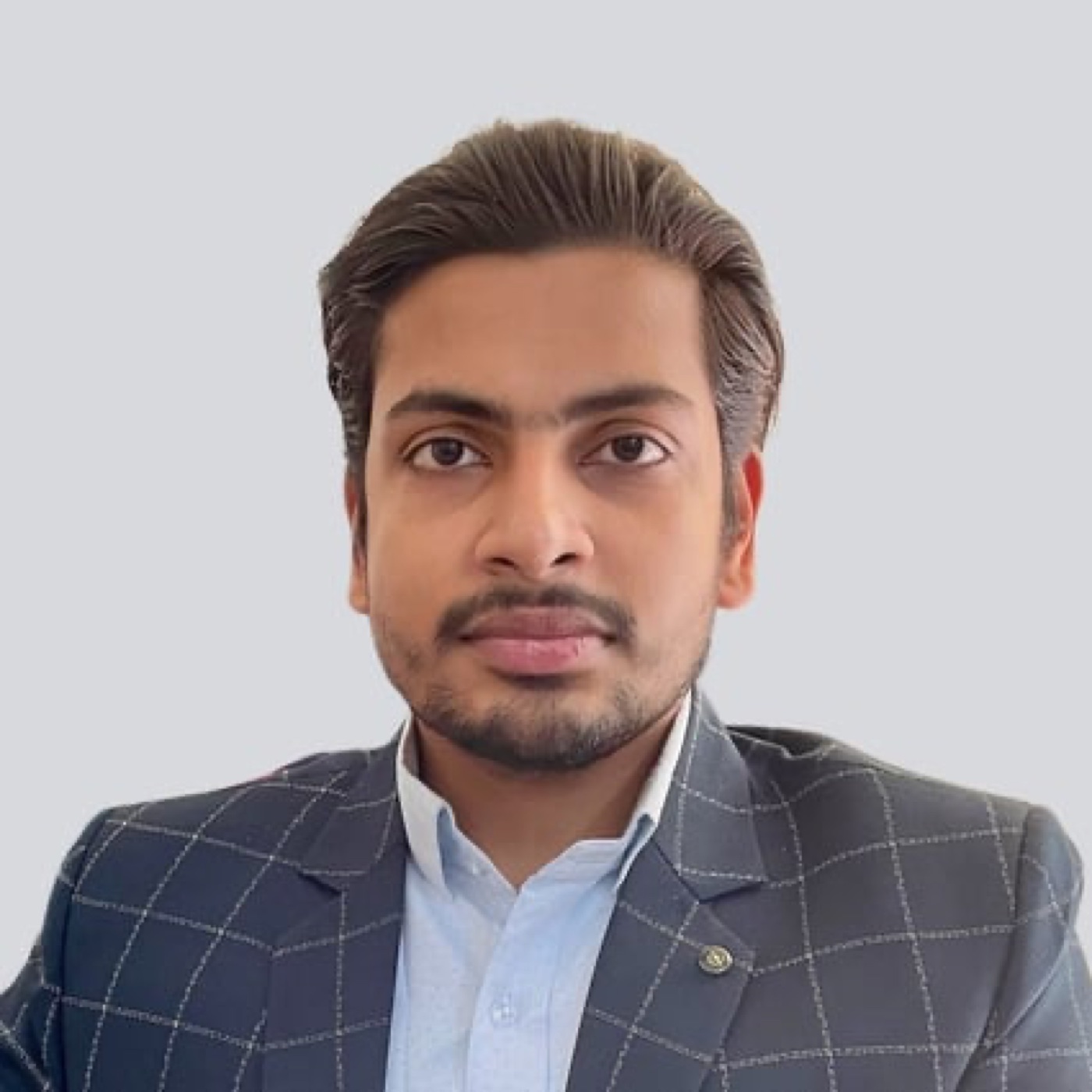 Formal portrait of Ankit in a checked blazer