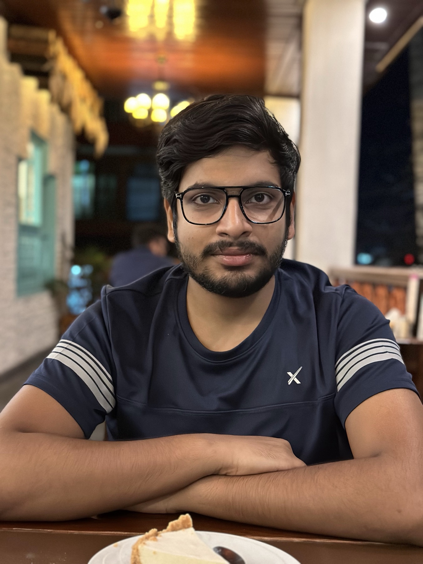 Ankit wearing glasses during a relaxed evening out
