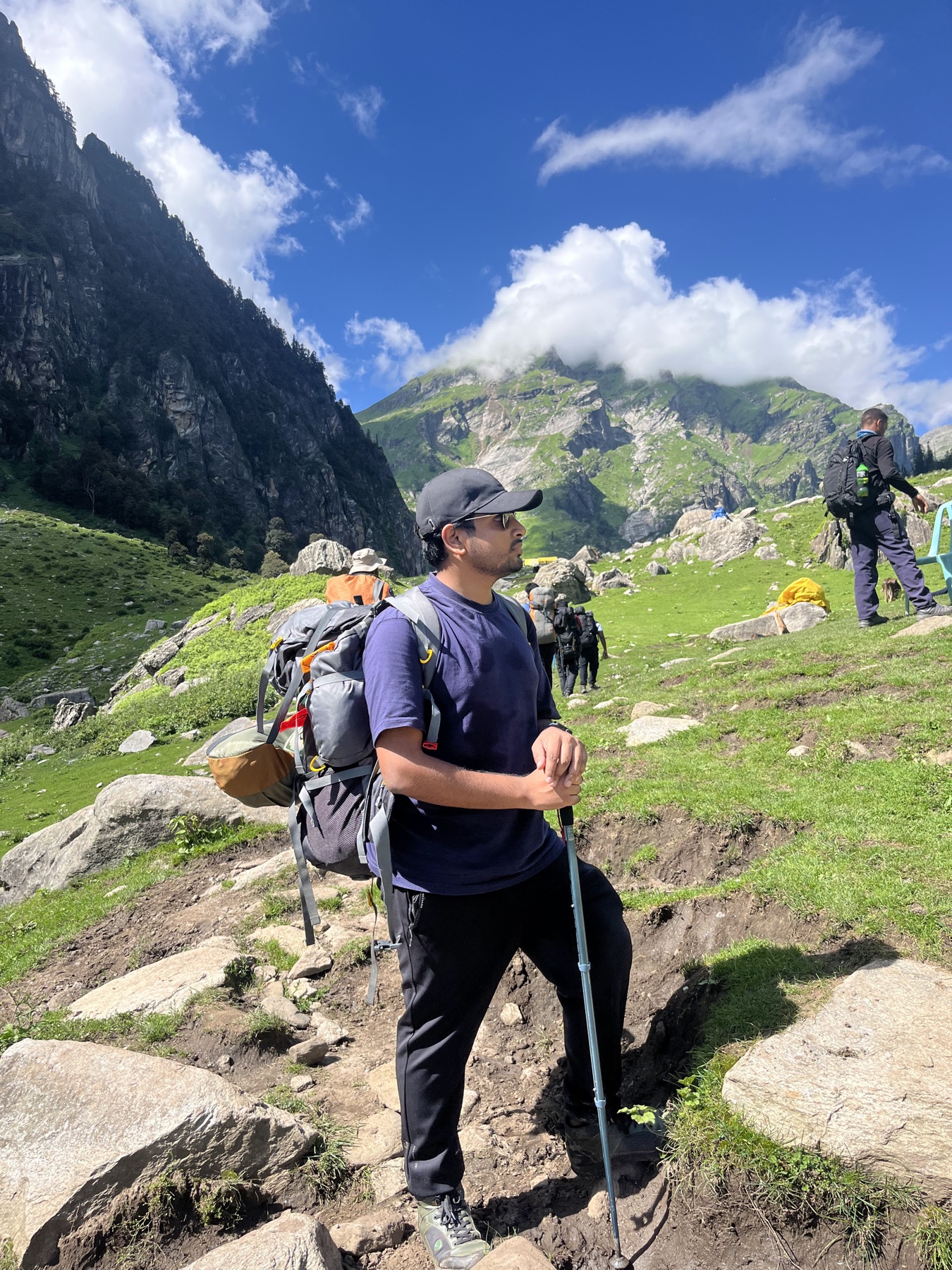 Ankit trekking through a green Himalayan valley