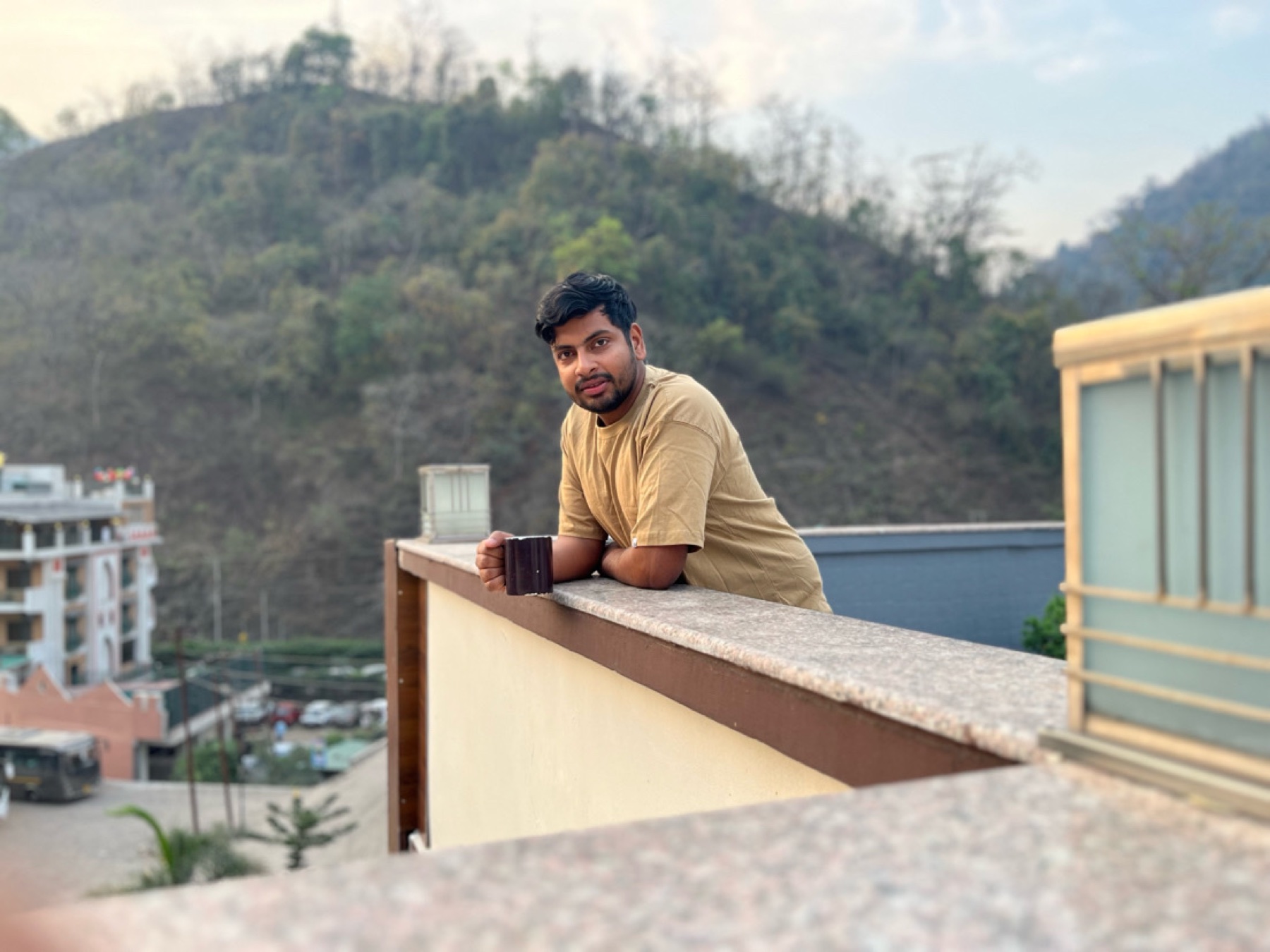 Ankit enjoying a quiet morning with a cup in the mountains